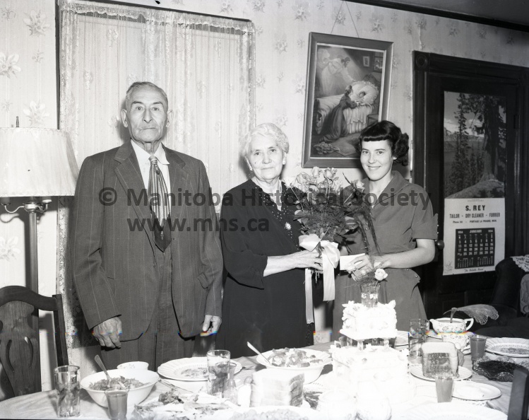 Tashiro, Oct. 15/54, Anniversary, Mr. & Mrs. Sylvester “Bert” hunt 50th anniversary, Mr. and Mrs. Sylvester “Bert” hunt of Poplar point receive congratulations to a bouquet of roses from their granddaughter, Jean McConnell, on the occasion of their golden wedding anniversary Friday, Oct. 15. Mr. and Mrs. Hunt were honoured at a family dinner at the home of their son- in – law and daughter, Mr. and Mrs. George D. Wood, 697-12th St. 10665a.jpg