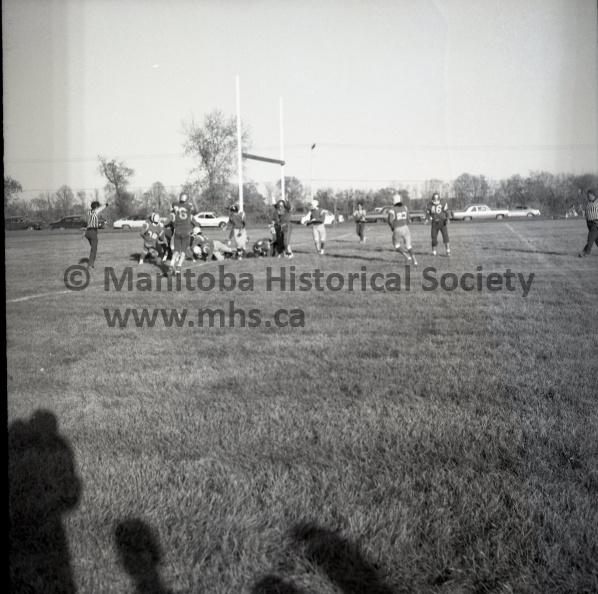 (Vopni) October 4th, 1973 PCI TROJANS PCI TROJANS HUMILIATE AMHS- INDIAN RESIDENCE COMBINE IN EXHIBITION MATCH PCI Trojan quarterback Harv Sanderson was just able to get this pass away as the AMHS-IRS line charges in. The quarterback received strong pressure but the defensive backs let the receivers get away on several occasions. Trojans used the long pass effectively to pile up a 38-0 win in the first football clash ever between the two Portage schools. 1573a.jpg