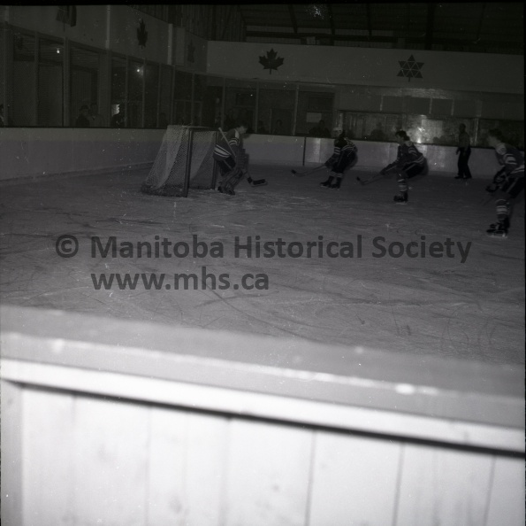 (Tashiro) Oct. 27/68 SPORTS
Terriers Walloped 11-3 by Selkirk Ridley stops 50 shots.
Portage Terriers netminder Curt Ridley steers one of 50 drives clear of his goal crease during the first period of Sundays MJHL hockey tilt. Despite Ridley's heroics 11 shots did go in as the Terriers dropped their fourth straight game, 11-3 to the Steelers. Terrier defenseman Craig Farncombe attempts to gibe Ridley a hand while Selkirk's Derrick Kuntz, 17, and an unidentified Steeler player move in for rebound 11283a.jpg