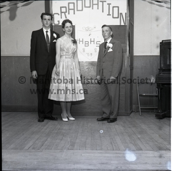 (Tashiro) May 15/1959 Social
High Bluff Has First Division Graduates.
High Bluff graduates - The 1959 graduating class from High Bluff high school as they graduated Friday night during special ceremonies in the High Bluff church. Left to right, they are Reg Milburn, Miss Moira Simmons and Jack Ediger. 11434c.jpg