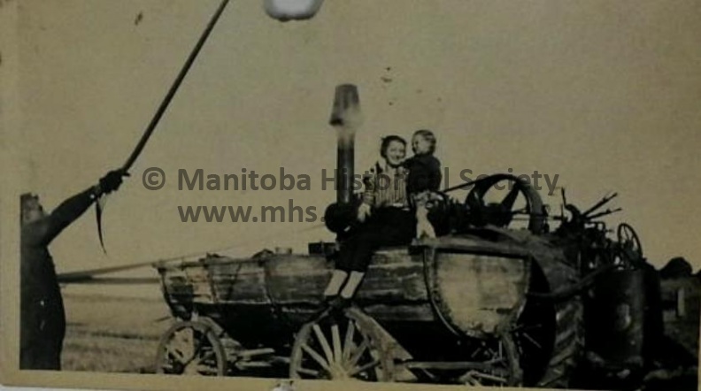 PHOTO OF MOM AND CHILD ON A STEAM TRACKTER.jpg