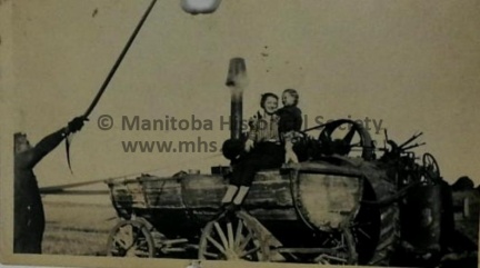 PHOTO OF MOM AND CHILD ON A STEAM TRACTER